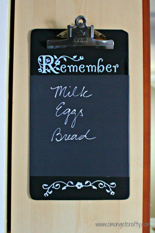 cmongetcraftyclipboardmakeoverfinal - C'mon Get Crafty Chalkboard painted clipboard hanging on the side of a cabinet