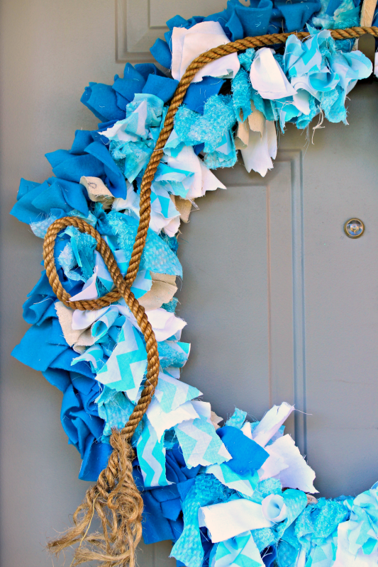 Inspired by the classic film JAWS, I used the ocean and one of my favorite quotes to create this fabric rag wreath for my front door! Come see how I took fabric scraps, wood, rope, and vinyl and created a nautical summer wreath! #MovieMondayChallenge