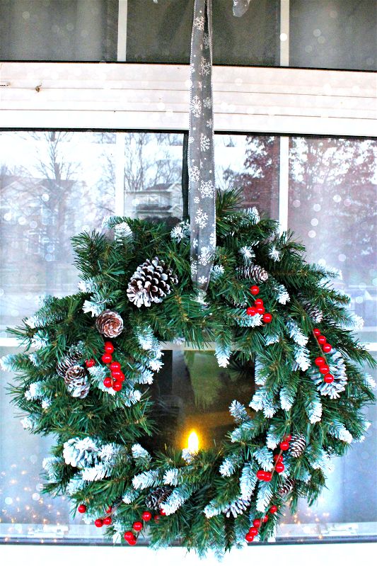 Add a touch of wintry elegance to your front porch decor with a beautiful wreath hung by ribbon over your window! 