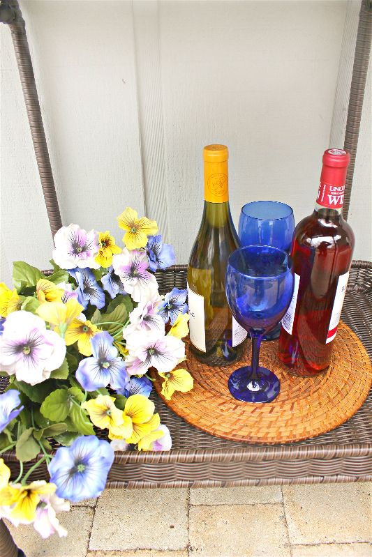 Bottom shelf wine flowers spring bar cart-opt - C'mon Get Crafty After the long Chicago winter, I'm SO ready to embrace the warmth of spring! Spend as much time outside as you can by styling a spring bar cart, always ready for outdoor entertaining! #ad #Wayfair #spring #barcart #sangria #springdecor