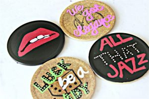 This painted coasters DIY is one of my favorite #MovieMondayChallenge crafts! I was so excited to design some of my favorite show lyrics into art! #paintedcoasters #sharpie #musicals #moviemonday #diy #sharpiecrafts #paintit #paintedcrafts #sharpiepaintpens #rockyhorrorpictureshow #hellodolly #guysanddolls #chicago #allthatjazz #luckbealady #lips #wegotelegance #picmonkey