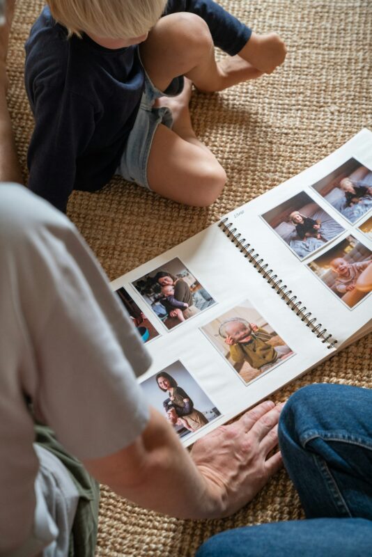 Photo by Kristyna Squaredone - C'mon Get Crafty a young boy sitting on the floor reading a book