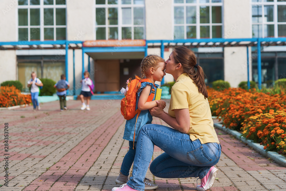 mother accompanies the child to school.