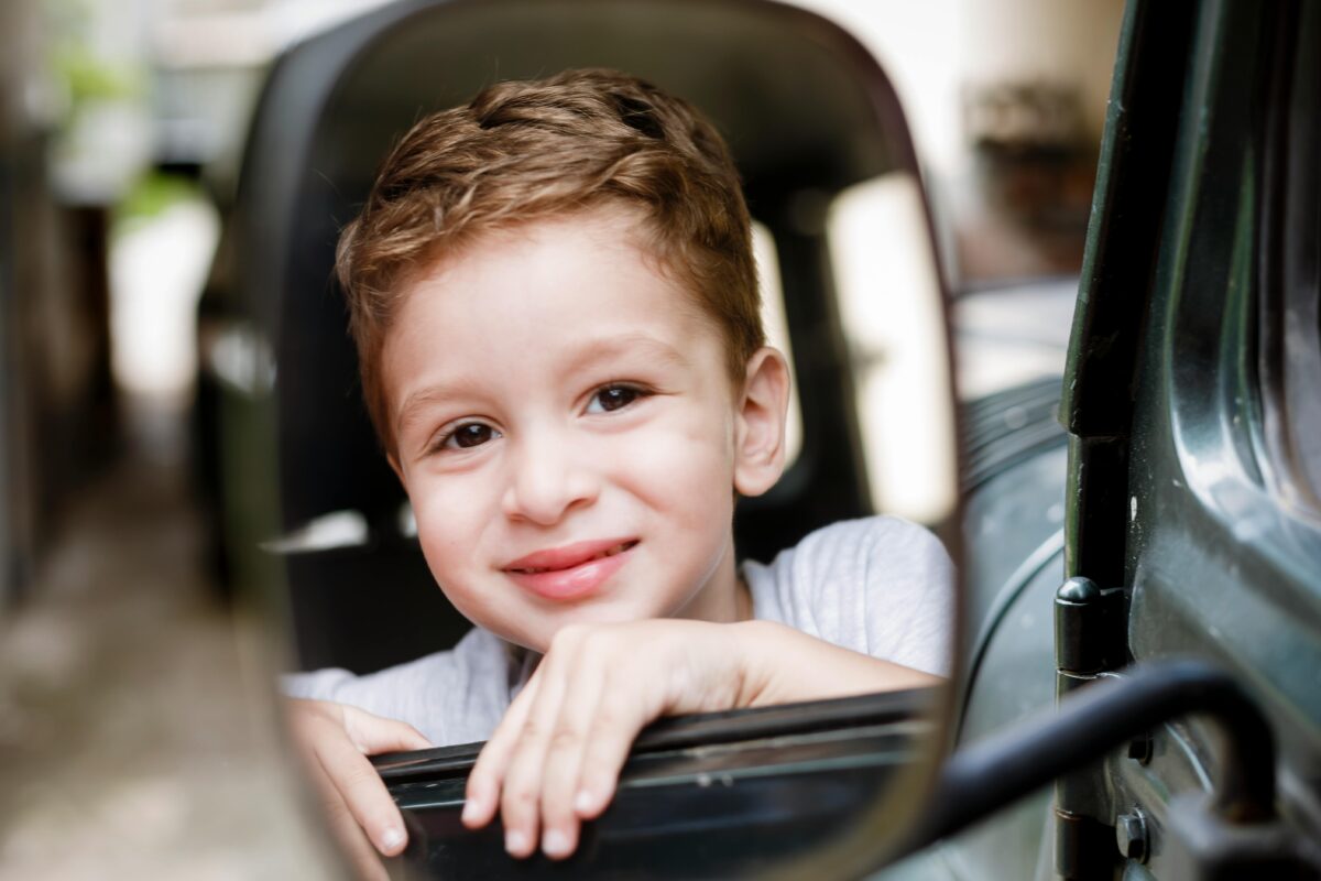 a-reflection-of-a-smiling-boy-in-car-side-mirror-stockpack-pexels - C'mon Get Crafty A reflection of a smiling boy in car side mirror
